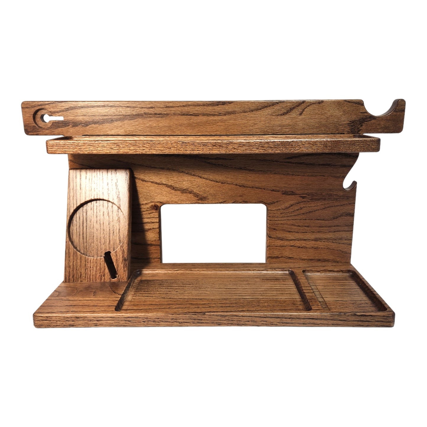 An empty CPAP Smart Stand made by Custom Cave Works.  The stand is on a white background and includes places to put your smartphone, smartwatch, change, keys and wallet.  The stand is sold oak wood that has a dark satin finish.  