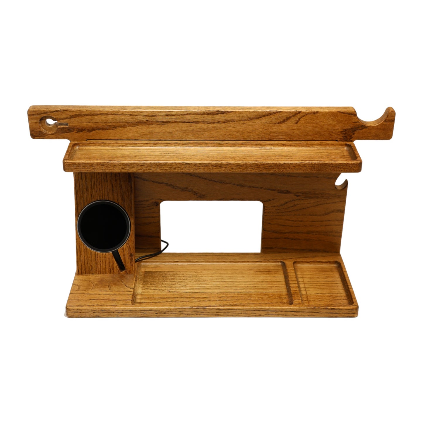 An empty CPAP Smart Stand made by Custom Cave Works.  This smart stand includes a wireless phone charger.  The stand is on a white background and includes places to put your smartphone, smartwatch, change, keys and wallet.  The stand is sold oak wood that has a satin finish.  